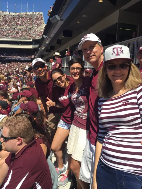Neuralog employees and friends in maroon at a Texas A&M football game