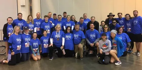 Neuralog team members with other Run for the Rose participants in matching blue T-shirts
